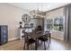 Inviting dining area with a modern chandelier and large window providing natural light at 15493 Kennewick, Noblesville, IN 46062