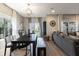 Open-concept dining room features a wooden table, bench seating, and lots of natural light from the sliding glass doors at 15493 Kennewick, Noblesville, IN 46062