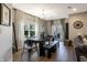 Elegant dining room with stylish table and chairs, lots of light and with a view to an outdoor patio at 15493 Kennewick, Noblesville, IN 46062