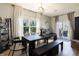 Dining room featuring a dark wooden table, contemporary light fixture, and sliding glass doors leading to an outdoor area at 15493 Kennewick, Noblesville, IN 46062