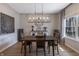 Well-lit dining room with a rustic sideboard, eye-catching wall art, and elegant chandelier at 15493 Kennewick, Noblesville, IN 46062