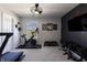 This is an exercise room with a Peloton and a treadmill as well as free weights and decorations at 15493 Kennewick, Noblesville, IN 46062