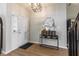 Bright foyer featuring wood flooring, a stylish mirror, and decor leading to other rooms at 15493 Kennewick, Noblesville, IN 46062