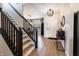 Elegant foyer with hardwood floors, a staircase, and stylish decor, creating a welcoming entrance to the home at 15493 Kennewick, Noblesville, IN 46062