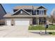 Charming two-story home with a well-manicured lawn, brick accents, and a three car garage at 15493 Kennewick, Noblesville, IN 46062