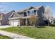 Charming two-story home with a well-manicured lawn, brick accents, and a three car garage at 15493 Kennewick, Noblesville, IN 46062