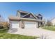 Charming two-story home with a well-manicured lawn, brick accents, and a three car garage at 15493 Kennewick, Noblesville, IN 46062