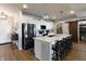 Well-equipped kitchen with an island, bar stool seating, stainless appliances, and white cabinetry at 15493 Kennewick, Noblesville, IN 46062