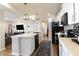 Stylish kitchen featuring white cabinets, black appliances, and an island with seating, perfect for modern living at 15493 Kennewick, Noblesville, IN 46062