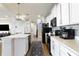 Charming kitchen with white cabinets, stainless steel appliances, and a large island with seating at 15493 Kennewick, Noblesville, IN 46062