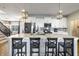 Bright kitchen featuring an island with seating, stainless steel appliances, and ample counter space at 15493 Kennewick, Noblesville, IN 46062