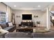 Spacious living room featuring a comfortable sectional sofa, modern entertainment center, and bright natural light at 15493 Kennewick, Noblesville, IN 46062