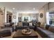 Comfortable living room with sectional sofa, rustic-chic decor, and dining area with view through large window at 15493 Kennewick, Noblesville, IN 46062