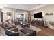 Inviting living room with a large sectional sofa, warm lighting, and a view of the backyard at 15493 Kennewick, Noblesville, IN 46062