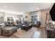 Cozy living room with a comfortable sectional sofa, rustic decor, and abundant natural light at 15493 Kennewick, Noblesville, IN 46062