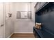 Stylish mudroom featuring navy blue built-in storage, coat hooks, and a bench, providing a functional and organized space at 15493 Kennewick, Noblesville, IN 46062