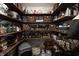 Well-stocked pantry with dark wood shelving and woven baskets, offering ample storage for kitchen supplies and food items at 15493 Kennewick, Noblesville, IN 46062