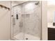 Elegant walk-in shower with white marble-style tile and glass enclosure at 15493 Kennewick, Noblesville, IN 46062