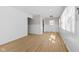 Bright living room with fresh white paint, contemporary light fixture, and sleek, light-colored wood flooring at 1836 N Riley Ave, Indianapolis, IN 46218