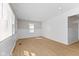 The living room features lots of natural light, fresh paint, and light-colored wood flooring at 1836 N Riley Ave, Indianapolis, IN 46218