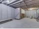 Unfinished basement featuring concrete walls, exposed wooden beams, stairs, and a bench at 1873 S 510 E, Franklin, IN 46131