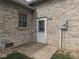 Back patio with window, door, and concrete platform and brick exterior at 1873 S 510 E, Franklin, IN 46131