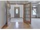 Inviting foyer with wood flooring, a decorative front door, and french doors to adjacent room at 1873 S 510 E, Franklin, IN 46131
