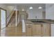 Kitchen island with sink, granite countertops and wood flooring overlooking the stairs at 1873 S 510 E, Franklin, IN 46131