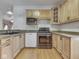 Bright kitchen showcases wood cabinets, granite counters, stainless steel appliances, and wood floor at 1873 S 510 E, Franklin, IN 46131