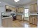 Kitchen features wood cabinetry, granite countertops, stainless appliances, and wood flooring at 1873 S 510 E, Franklin, IN 46131