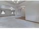 Spacious living room featuring plush carpeting, large windows, and elegant archways to other rooms at 1873 S 510 E, Franklin, IN 46131