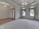Spacious living room featuring archways, chandelier and large windows with decorative curtains at 1873 S 510 E, Franklin, IN 46131