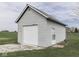 Exterior view of a detached garage with white siding and a roll-up door at 1873 S 510 E, Franklin, IN 46131
