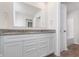 Bathroom with double sink vanity, granite counters, large mirror, and wood-look flooring at 18769 Moray St, Westfield, IN 46074