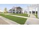 A clubhouse exterior with a pergola walkway, lush green lawn, and fresh landscaping at 18769 Moray St, Westfield, IN 46074