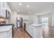 Bright and spacious kitchen featuring white cabinets, stainless steel appliances, and a quartz countertop island at 18769 Moray St, Westfield, IN 46074