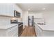 Modern kitchen featuring stainless steel appliances, quartz countertops, white cabinets and hardwood flooring at 18769 Moray St, Westfield, IN 46074