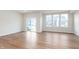 Spacious living room featuring hardwood flooring, large windows, and a sliding glass door to the backyard at 18769 Moray St, Westfield, IN 46074