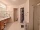 Bright bathroom featuring a large mirror, spacious vanity, and a glass door shower at 2179 W Van Arsdall Ct, Columbus, IN 47201