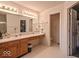 Bright bathroom featuring a large mirror, spacious vanity, and a glass door shower at 2179 W Van Arsdall Ct, Columbus, IN 47201