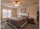 Bedroom featuring a bed, a ceiling fan, and a large window at 2179 W Van Arsdall Ct, Columbus, IN 47201