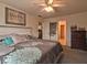 Bedroom featuring a bed, a ceiling fan, and a large window at 2179 W Van Arsdall Ct, Columbus, IN 47201