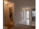 Bright hallway featuring neutral walls, practical flooring, and convenient access to the bathroom at 2179 W Van Arsdall Ct, Columbus, IN 47201