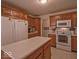 Bright kitchen boasting plenty of cabinet space, and views to both appliances and laundry room at 2179 W Van Arsdall Ct, Columbus, IN 47201