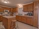 Functional kitchen with updated appliances, wood cabinetry and plenty of countertop space at 2179 W Van Arsdall Ct, Columbus, IN 47201