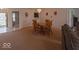 Open-concept living area featuring neutral carpeting, dining area and plenty of natural light at 2179 W Van Arsdall Ct, Columbus, IN 47201