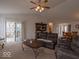 Spacious living room featuring a ceiling fan, a dining area, and a sliding door to the outside patio at 2179 W Van Arsdall Ct, Columbus, IN 47201