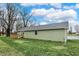 Side view of the property highlighting its well-maintained siding and serene backyard setting at 2264 Walnut W St, Greenfield, IN 46140