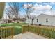 Spacious backyard with a new deck, grass, and mature trees at 2264 Walnut W St, Greenfield, IN 46140