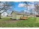 An inviting view of the backyard featuring a wooden deck, manicured lawn, and tasteful siding at 2264 Walnut W St, Greenfield, IN 46140